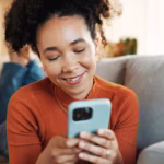 home-relax-woman-sofa-cellphone-typing-with-smile-texting-social-media-online-reading-person-girl-couch-smartphone-mobile-user-with-internet-connection-chatting_590464-490141